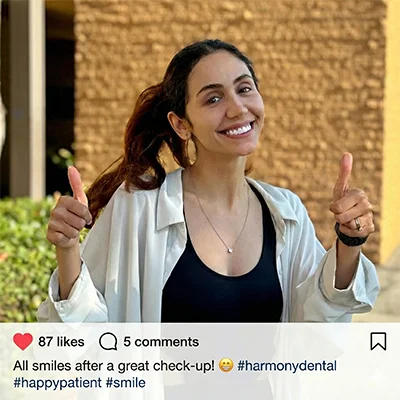 A happy, smiling patient standing outside the My La Mirada Dentist clinic after a comfortable and successful dental visit